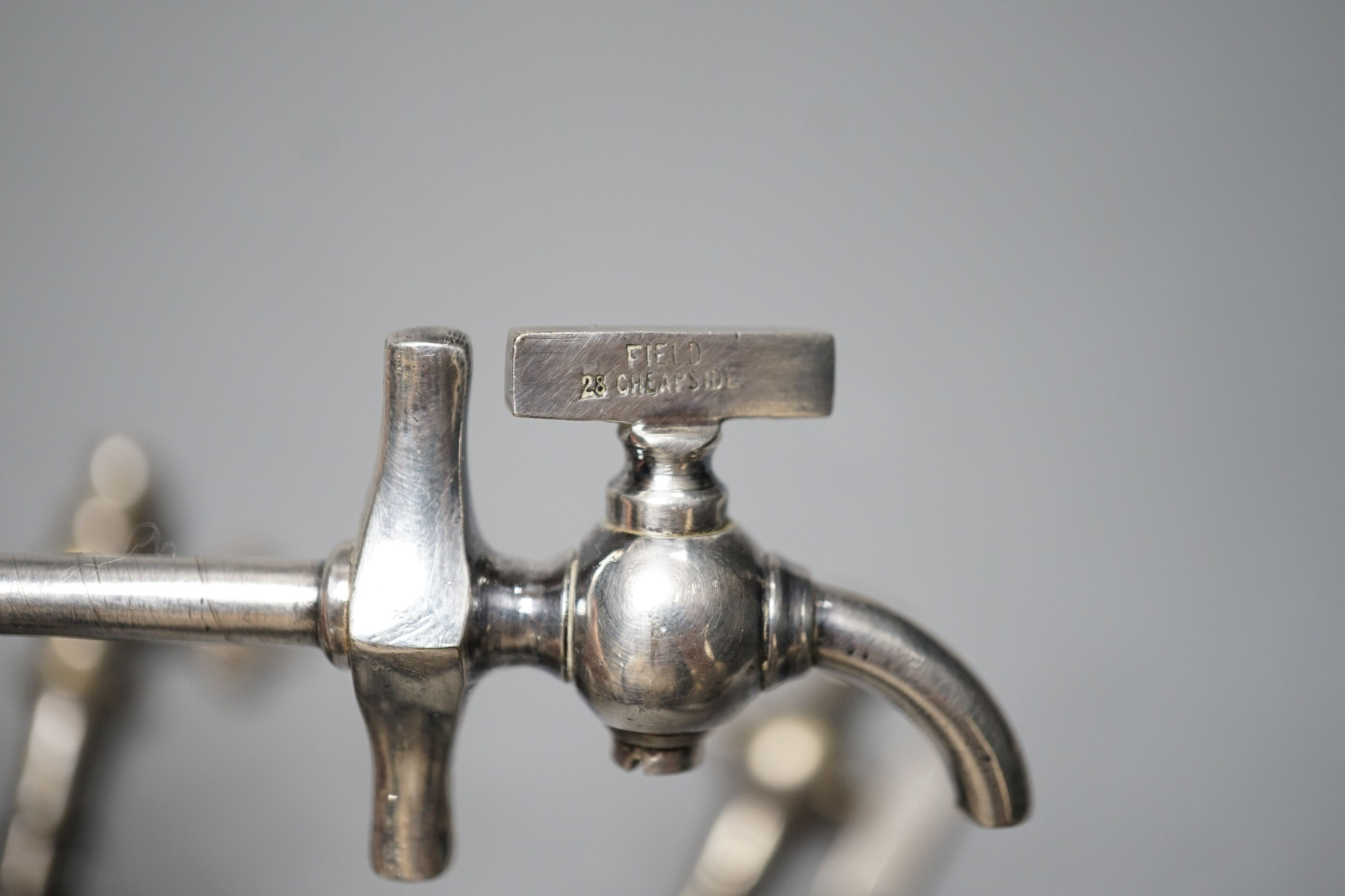 An S. Maw & Son champagne tap and four others, one in original leather case